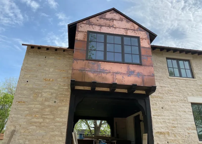 Copper metal panel facade on a stone building for Skylight Installation in Buena Vista